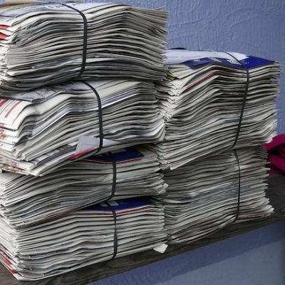 two piles of bundled waste newspapers made ready for disposal or recycling