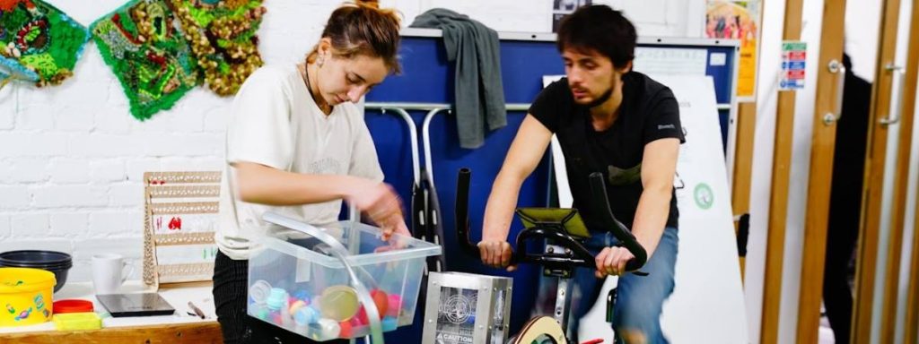 two workshop participants on the plastic schredding bike, one of the activities at the workshop